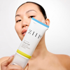 Woman holding the ZIIP Clear Gel